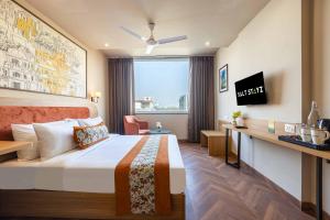 a hotel room with a bed and a desk at Saltstayz Select- Medicity Near Medanta Hospital in Gurgaon