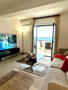a living room with a couch and a large screen tv at Villa Bavaria Trogir in Trogir