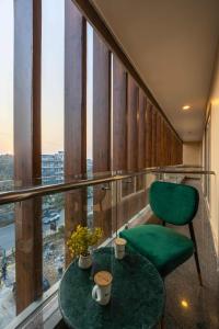 a room with a table and a chair and a window at Saltstayz Select- Medicity Near Medanta Hospital in Gurgaon +42 photos