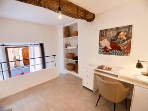 a room with a desk and a painting on the wall at Cabris Village Escape - Junior Suite in Cabris