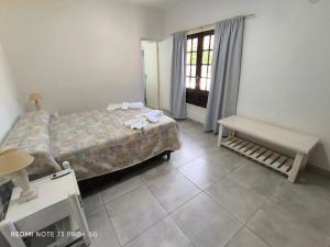 a bedroom with a large bed and a window at Casa hasta 10 personas. in Villa Rumipal +11 photos