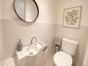 a bathroom with a toilet and a sink and a mirror at Cabris Village Escape - Junior Suite in Cabris +13 photos