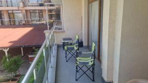 a balcony with two chairs and a table at Apart Complex Pontica - Sea View 20 in Chernomorets