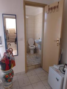 a bathroom with a toilet and a sink at Ippocampo in Giardini Naxos