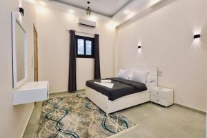 a white bedroom with a bed and a window at Nile Kingdom Guest house in Luxor +157 photos