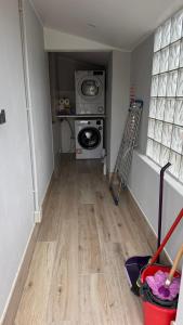 a laundry room with a washer and dryer at Apartamento do Lagar, Praia da Abrela in O Vicedo