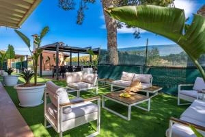 a patio with white furniture and a table and chairs at Villa Salvaje Beach in San Francesch