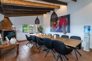 a dining room with a table and chairs and a fireplace at Villa Salvaje Beach in San Francesch