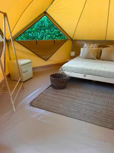 a bedroom in a tent with a bed and a rug at Camping Playa América Nigrán in Playa América