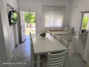 a living room with a table and a couch at Casa hasta 10 personas. in Villa Rumipal