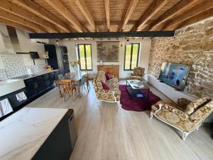 a large living room with a stone wall at Chez Mémé Cécile in Montluçon