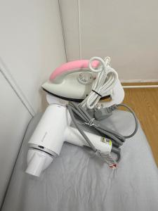 a white and pink hair dryer sitting in a room at Kuantan Tiny Homestay in Kuantan
