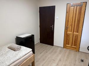 a room with a bed and a wooden door at Ubytování U Dědečka in Lomnice nad Lužnicí