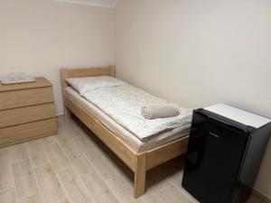 a small bedroom with a bed and a dresser at Ubytování U Dědečka in Lomnice nad Lužnicí