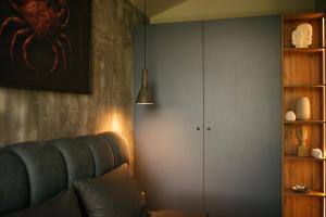 a living room with a blue couch and a cabinet at RAC by Zodiac Resort in Ceraşul