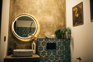a bathroom with a sink and a mirror at RAC by Zodiac Resort in Ceraşul