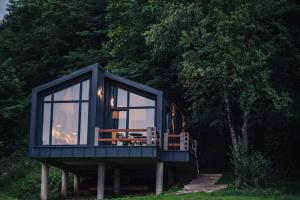 a blue house with a table and chairs in it at RAC by Zodiac Resort in Ceraşul