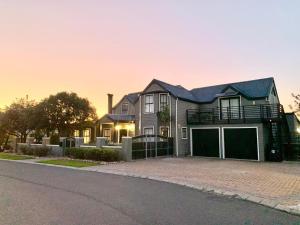 a large house with a garage on a street at Imhoff's Gift Sweet Escape in Imhoffʼs Gift