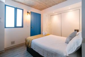 a bedroom with a large bed and a window at Casa do Sol by Amazing Madeira in Jardim do Mar +36 photos