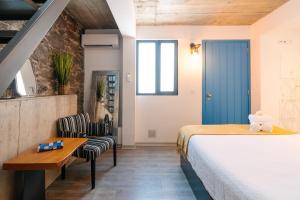 a bedroom with a bed and a table and chairs at Casa do Sol by Amazing Madeira in Jardim do Mar