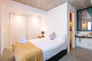 a bedroom with a large white bed and a window at Casa do Sol by Amazing Madeira in Jardim do Mar