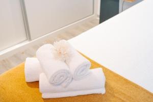 a pile of towels on a table in a bathroom at Casa do Sol by Amazing Madeira in Jardim do Mar