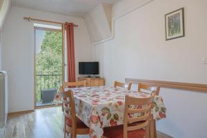 a dining room with a table and chairs and a television at Pivka Na Meji Resort in Pivka
