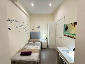 a small room with two beds and a table at Rooms Balmes in Barcelona +23 photos