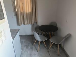 a table and two chairs in a small room at Alexandros and Georgia in Ipsos +27 photos