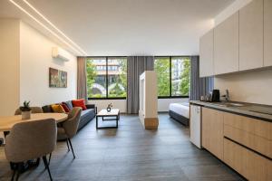 a kitchen and living room with a table and a couch at Middle Beach Hotel in Jounieh