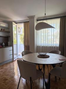 a kitchen and dining room with a table and chairs at BL Urban Stay in Starčevica +13 photos