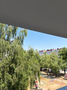 a view of a park with trees and a playground at BL Urban Stay in Starčevica