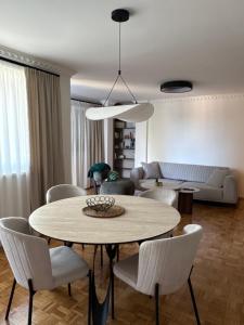 a living room with a table and chairs at BL Urban Stay in Starčevica