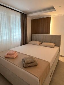 a bedroom with a large bed with two towels on it at BL Urban Stay in Starčevica