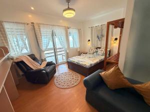 a bedroom with a bed and a couch and a chair at Farmer’s Cafe Villas in Burgos