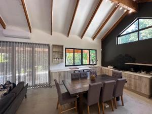 a kitchen and dining room with a wooden table and chairs at Sand River Guest House in Johannesburg