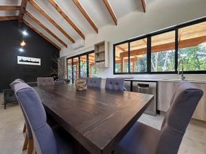 a kitchen with a large wooden table and chairs at Sand River Guest House in Johannesburg +173 photos