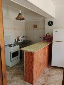 a kitchen with a white stove and a white refrigerator at Super star Chalet in Grand beach in Ras Sedr