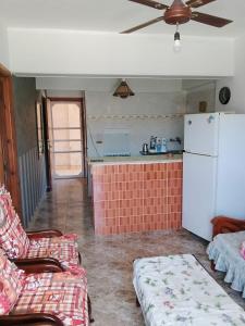 a living room with a white refrigerator and a couch at Super star Chalet in Grand beach in Ras Sedr