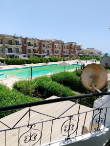 a view of a swimming pool from a balcony at Super star Chalet in Grand beach in Ras Sedr
