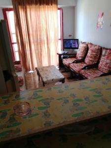 a living room with a table and a couch at Super star Chalet in Grand beach in Ras Sedr