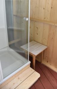 a sauna with a bench and a glass wall at Countryside Eco Natuurhuisjes in Ee +34 photos