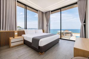 a bedroom with a bed with a view of the ocean at Middle Beach Hotel in Jounieh