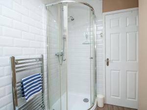 a shower with a glass door in a bathroom at Hideaway Cottage in Hunstanton +20 photos