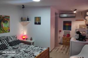 a bedroom with a bed and a room with at Suzy's nest room in Asprovalta
