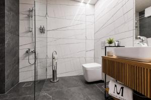 a bathroom with a shower and a sink and a toilet at Middle Beach Hotel in Jounieh +31 photos