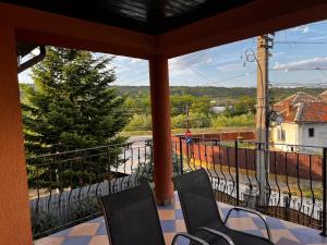 a porch with two chairs and a balcony with a view at Vila Ovi Salin in Turda