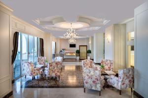a living room with chairs and a chandelier at Oz Hotels Side Premium in Side