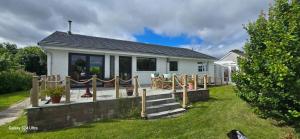 a white house with a porch and a yard at Beautiful Highland Sanctuary in Embo
