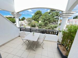 a white table and chairs on a balcony at Le Cocon Baulois in La Baule